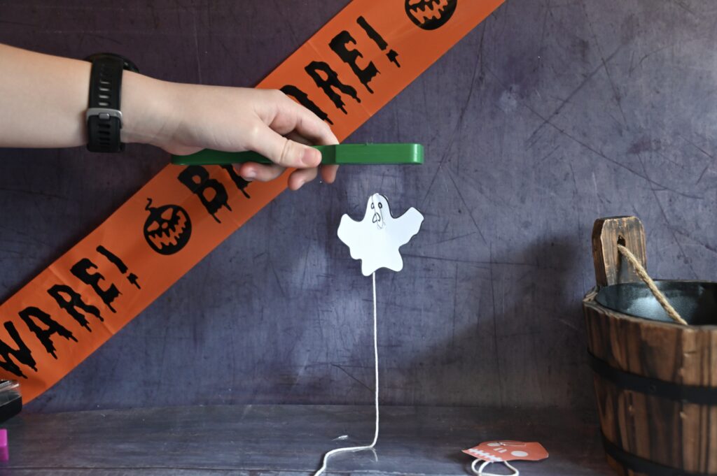 paper ghost that seems to be suspended in the air thanks to the attraction between a magnet and paper clip