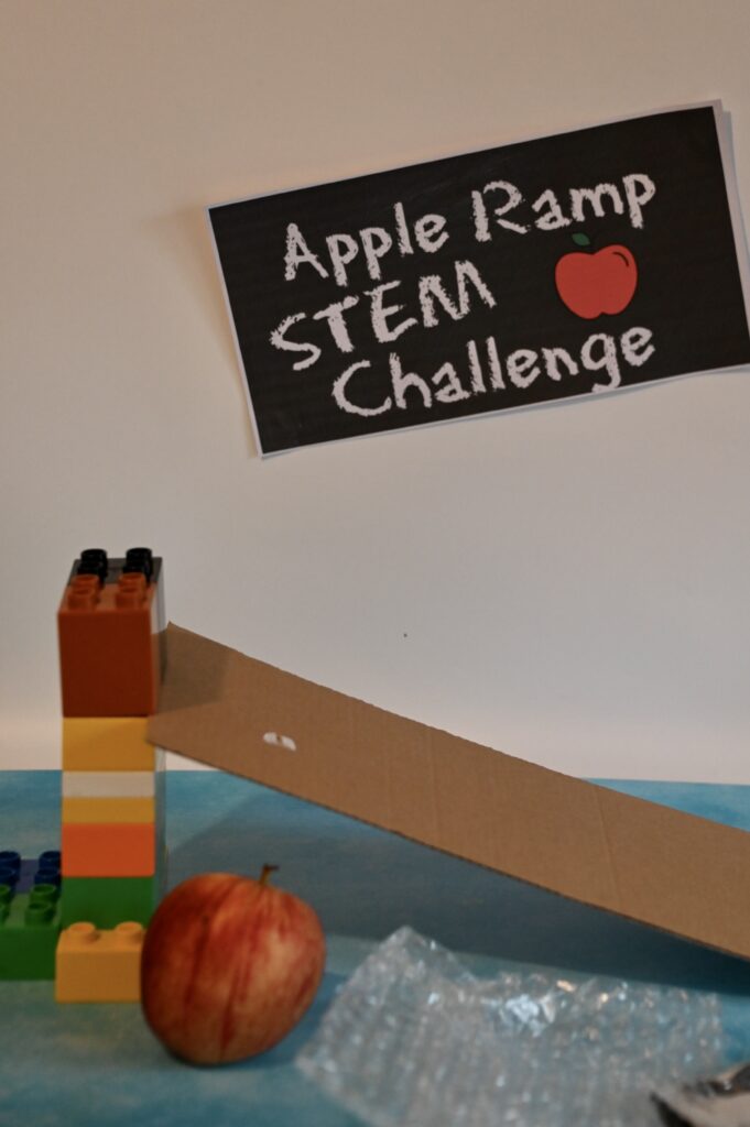 apple ramp STEM challengeA ramp made from building blocks and thick cardboard